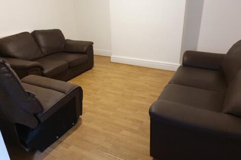A cozy living room featuring comfortable brown ...