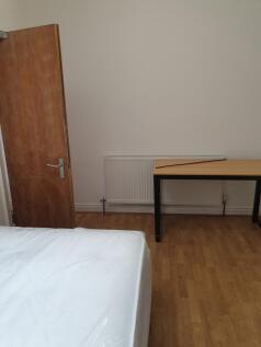 This inviting double bedroom features a comfort...