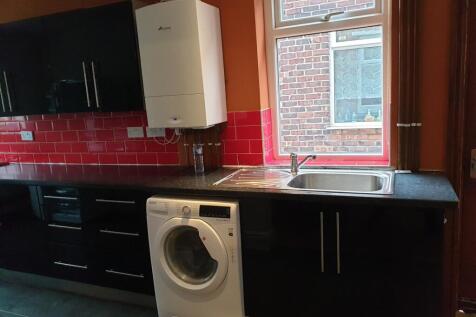 This stylish kitchen features modern black cabi...