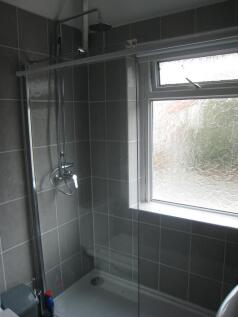 This modern bathroom features a sleek shower wi...