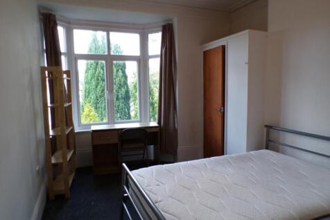 Spacious double bedroom featuring large windows...