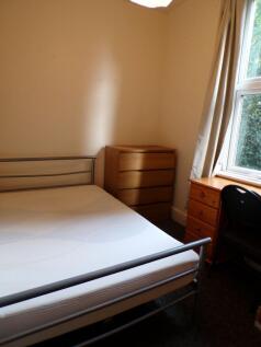 A functional student bedroom featuring a simple...