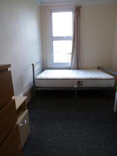 A cozy double bedroom featuring a large window ...
