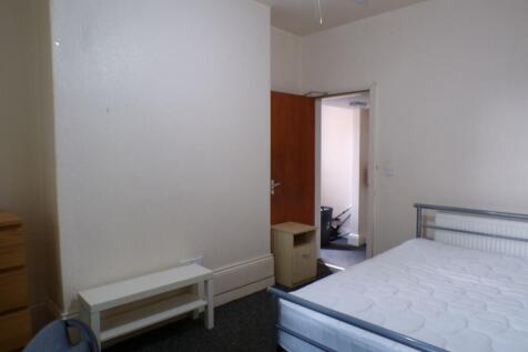 A bright and spacious bedroom featuring a doubl...