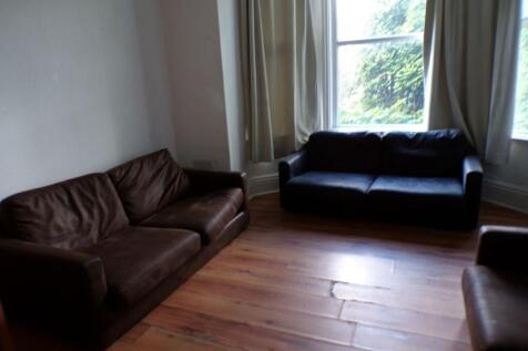 A cozy living room featuring two leather sofas ...