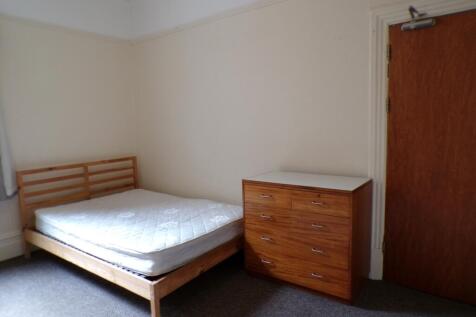 A spacious double bedroom with a clean layout, ...
