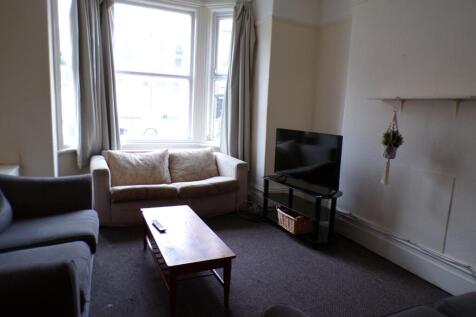 A cozy living room with ample natural light, pe...