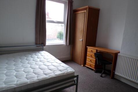 A spacious double bedroom with natural light, p...
