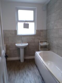A modern bathroom featuring a spacious layout a...