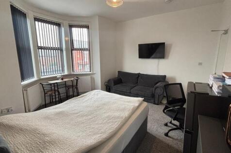 Spacious master bedroom featuring a comfortable...