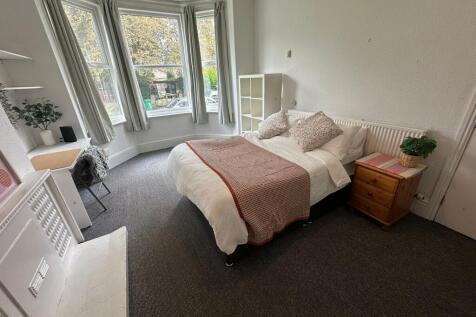 Bright and welcoming living room with large bay...