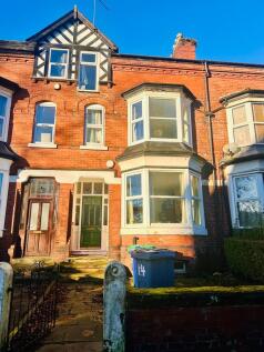 A charming exterior view of a traditional red-b...