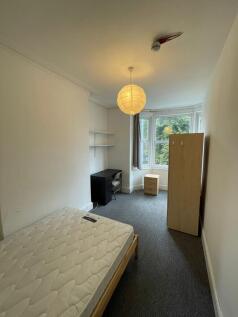 A spacious and bright double bedroom featuring ...