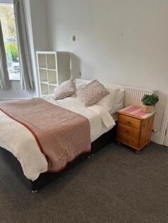 A cozy bedroom featuring a double bed with flor...