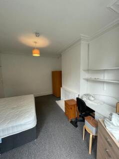 A spacious and bright double bedroom featuring ...
