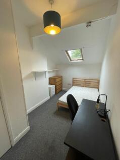 A spacious and well-lit double bedroom featurin...