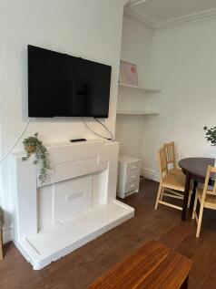 A cozy and well-maintained living room featurin...