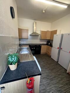 A functional kitchen featuring a double sink, a...