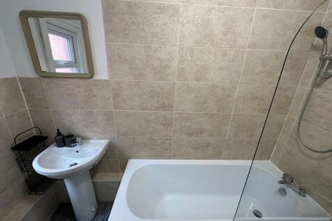 A clean and functional bathroom featuring a bat...