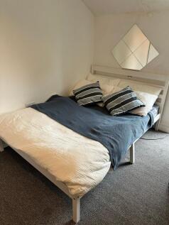 A spacious and well-maintained bedroom featurin...