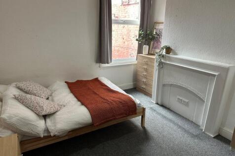 A bright and cozy double bedroom featuring a co...