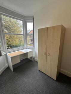 Bright and simple single bedroom featuring a la...