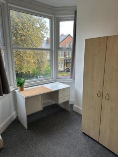 A compact toilet room featuring a simple design...