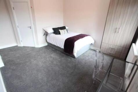 A clean and bright single bedroom featuring a c...