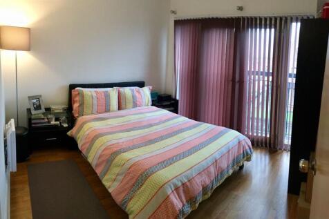 A bright and well-kept master bedroom featuring...
