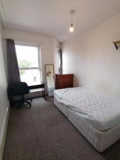 A bright and spacious double bedroom with a com...