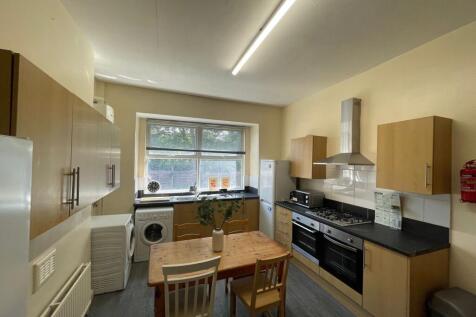 Bright and modern kitchen featuring a large win...