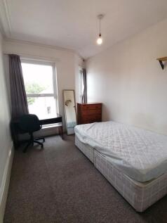 Spacious double bedroom featuring a comfortable...