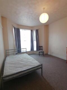 Spacious double bedroom featuring large windows...