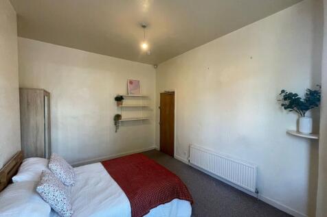 A cozy and well-maintained bedroom featuring a ...