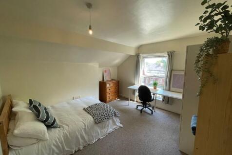 Bright and cozy bedroom featuring a single bed ...
