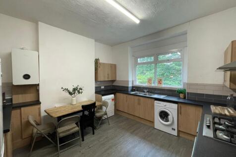 Bright and modern kitchen featuring ample natur...