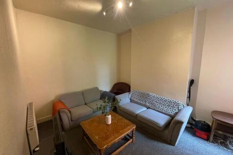 A cozy living room featuring two sofas, a woode...