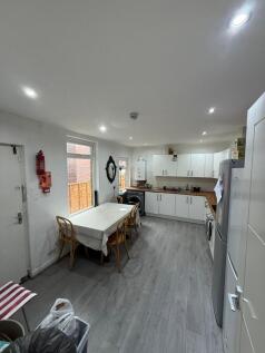 A bright kitchen featuring a spacious dining ta...