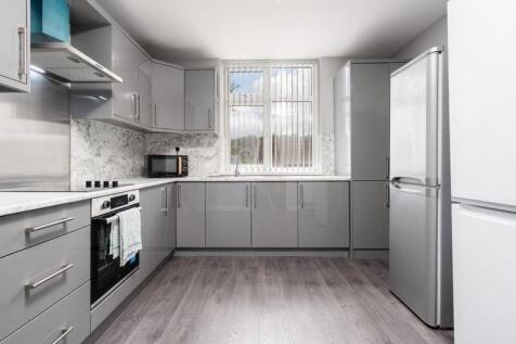 Modern kitchen featuring sleek grey cabinets an...
