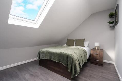 This charming double bedroom features a cozy am...