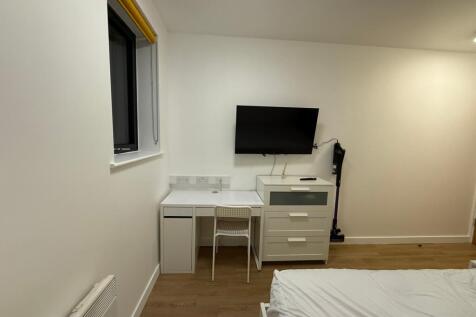 This inviting double bedroom features a comfort...