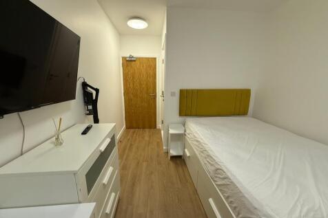 Bright and modern double bedroom featuring a co...
