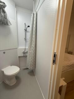 A modern bathroom featuring a sleek shower area...
