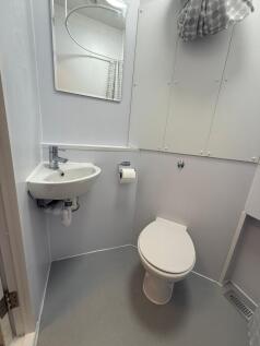 A modern bathroom featuring a clean design with...