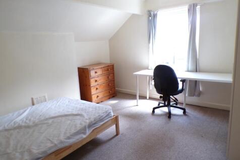 A spacious and bright double bedroom featuring ...