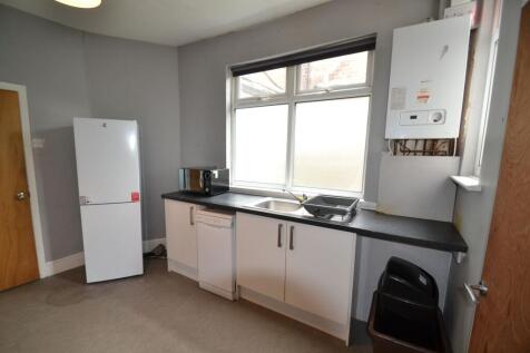 A simple and functional kitchen featuring a lar...