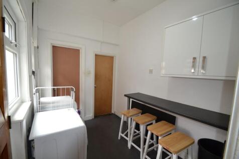 Bright kitchen area with a long black counterto...