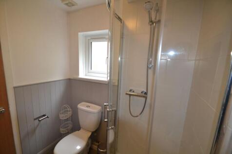 Bright and clean bathroom featuring a modern sh...