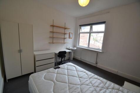 A neat and functional single bedroom featuring ...