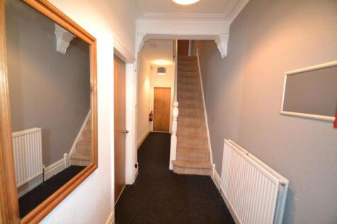 A clean and well-maintained hallway featuring a...